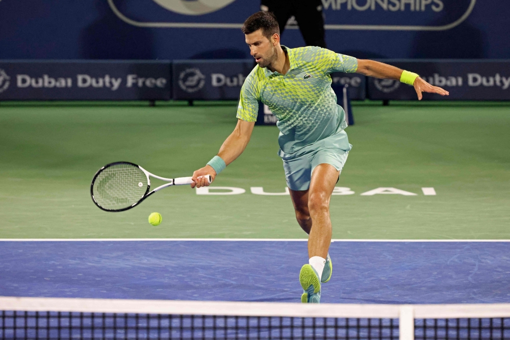 Serbia's Novak Djokovic hits a return against Poland's Hubert Hurkacz (not pictured) during their Dubai Duty Free Tennis Championship match in Dubai on March 2, 2023. (Photo by Karim SAHIB / AFP)