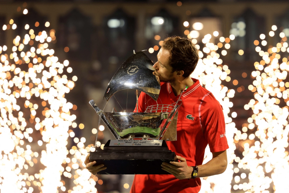 Russia's Daniil Medvedev kisses his trophy after winning against Andrey Rublev during the ATP Dubai Duty Free Tennis Championship final match in Dubai, on March 4, 2023. (Photo by Karim SAHIB / AFP)