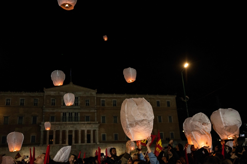 Supporters of the Greek Communist party release lanterns in front of the parliament during a protest following the deadly train accident near the city of Larissa, where 57 people, mainly students lost their live, in Athens on March 4, 2023. Photo by Angelos Tzortzinis / AFP