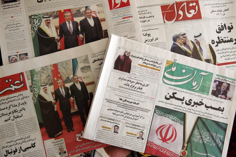 Newspapers in Tehran feature on their front page news about the China-brokered deal between Iran and Saudi Arabia to restore ties, signed in Beijing the previous day, on March 11, 2023. (Photo by Atta Kenare / AFP)
