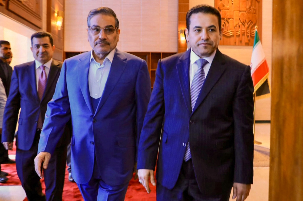 In this handout photo released by Iraq's National Security press office, Iraq's National Security Advisor Qasim al-Araji (right) meets with the Secretary of Iran's Supreme National Security Council Ali Shamkhani (centre) in Baghdad on March 19, 2023. (Photo by IRAQI SECURITY MEDIA CENTRE / AFP)