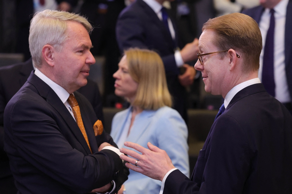 Finland Minister for Foreign Affairs Pekka Haavisto (left) and Sweden's Foreign Minister Tobias Billstroem (right) speak prior to attending a round table during the North Atlantic Council (NAC) Ministers of Foreign Affairs meeting at the NATO headquarters in Brussels on April 5, 2023. (Photo by Olivier Matthys / POOL / AFP)