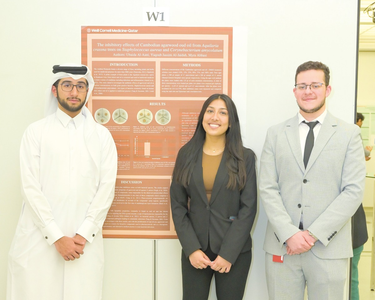 Yaqoub Jassim Al Jaidah, Myra Abbasi and Ubaida Al Aani presenting a poster on the inhibitory effect of Cambodian agarwood oud oil.  