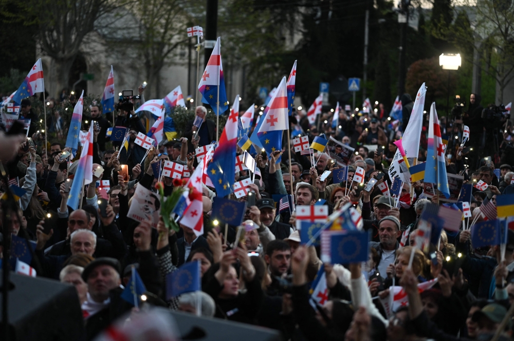 Georgian opposition supporters rally in the center of Tbilisi on April 9, 2023. (Photo by Vano Shlamov / AFP)