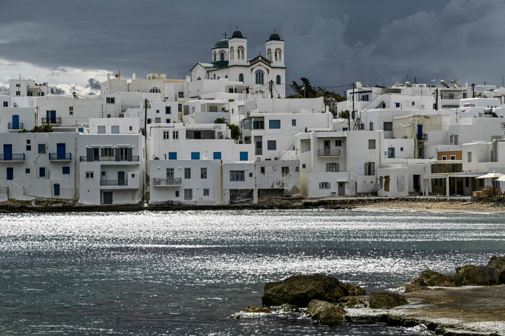 A photo shows buildings in the village of Naoussa, in Greece's popular travel island of Paros, on April 6, 2023. Photo by Louisa GOULIAMAKI / AFP