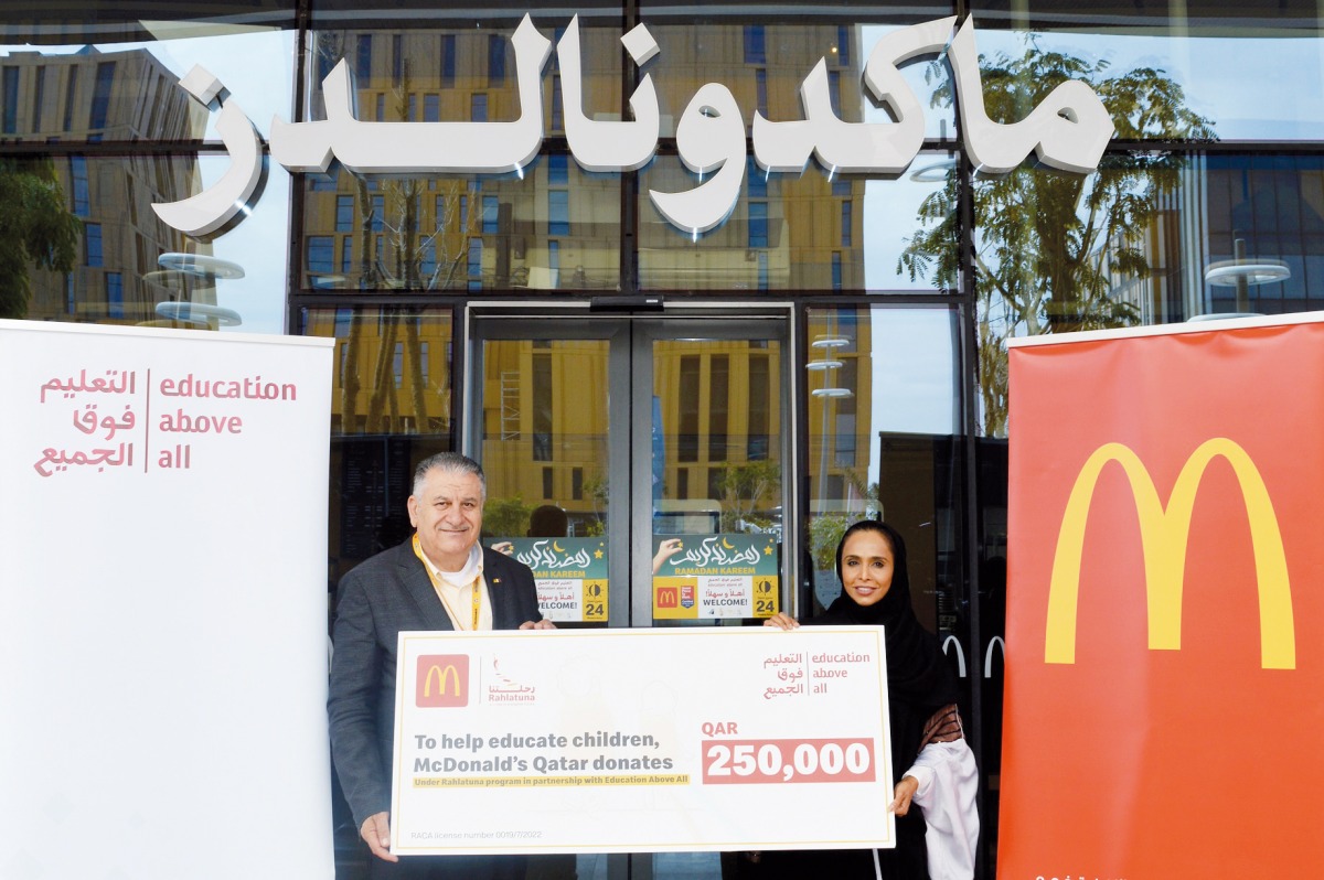 General Manager of McDonald’s Qatar Mithqual Abunasser (left) hands over a ceremonial cheque to Director of Partnerships at EAA Foundation Taj Sulaiman.