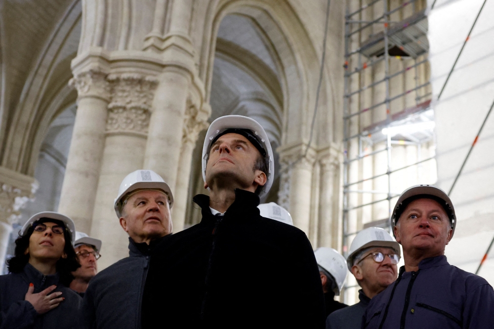 French Culture Minister Rima Abdul Malak, French Army General Jean-Louis Georgelin, French President Emmanuel Macron and Chief architect Philippe Villeneuve, wearing working helmets, visit the restoration site at the Notre-Dame de Paris Cathedral, which was damaged in a devastating fire four years ago, in Paris, France, April 14, 2023. Photo by SARAH MEYSSONNIER / POOL / AFP