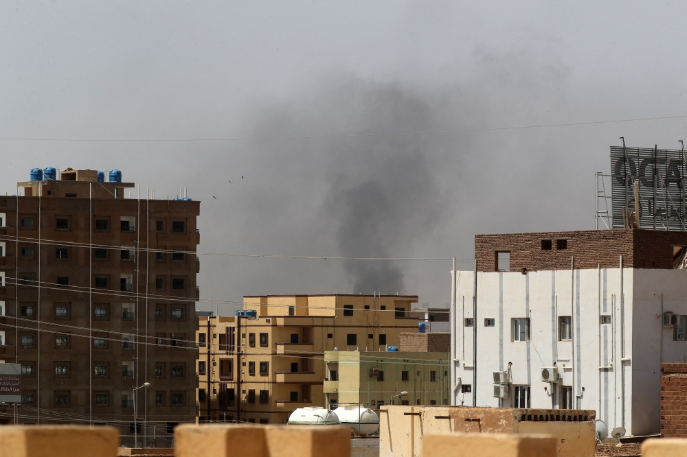 Smoke rises above buildings in Khartoum on April 15, 2023, amid reported clashes in the city. (Photo by AFP)