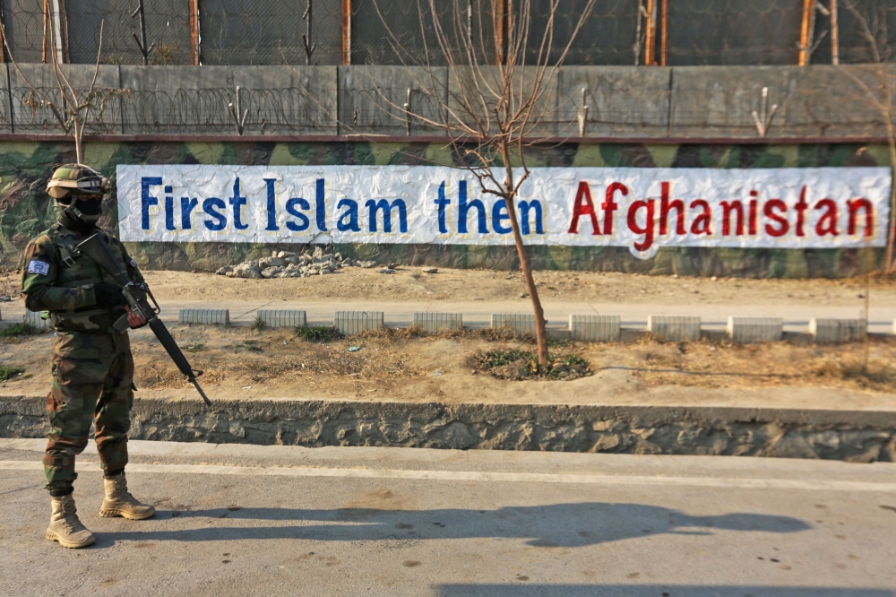 A Taliban fighter stands guard along a street in Kabul on December 27, 2022. (AFP)