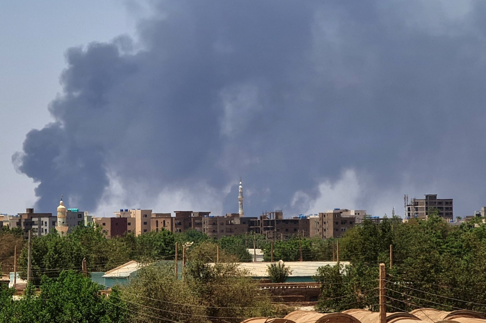 Smoke billows over buildings in Khartoum on May 1, 2023 as deadly clashes between rival generals' forces have entered their third week. (Photo by AFP)