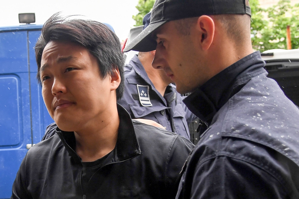 :South Korean cryptocurrency entrepreneur, co-founder of Terraform Labs (Terra Luna), Do Kwon (L), is taken to court in Podgorica on May 11, 2023, following his arrest on March 24 at the Montenegrin capital's international airport. (Photo by SAVO PRELEVIC / AFP)
