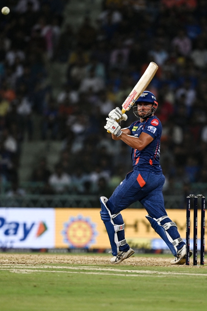 Lucknow Super Giants' Marcus Stoinis plays a shot during the Indian Premier League (IPL) Twenty20 cricket match between Mumbai Indians and Lucknow Super Giants at the Ekana Cricket Stadium in Lucknow on May 16, 2023. (Photo by Arun SANKAR / AFP)