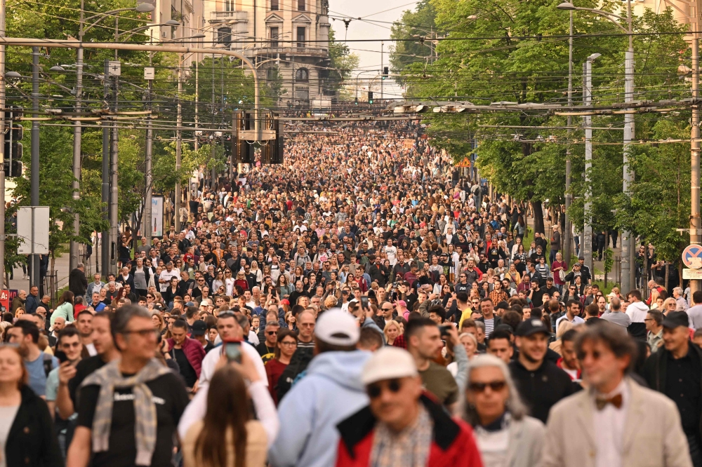 Thousands of protesters march during a rally to call for the resignation of top officials and curtailing violence in the media, after two mass shootings that killed 18 people earlier this month, in Belgrade, on May 19, 2023. (Photo by Andrej Isakovic / AFP)