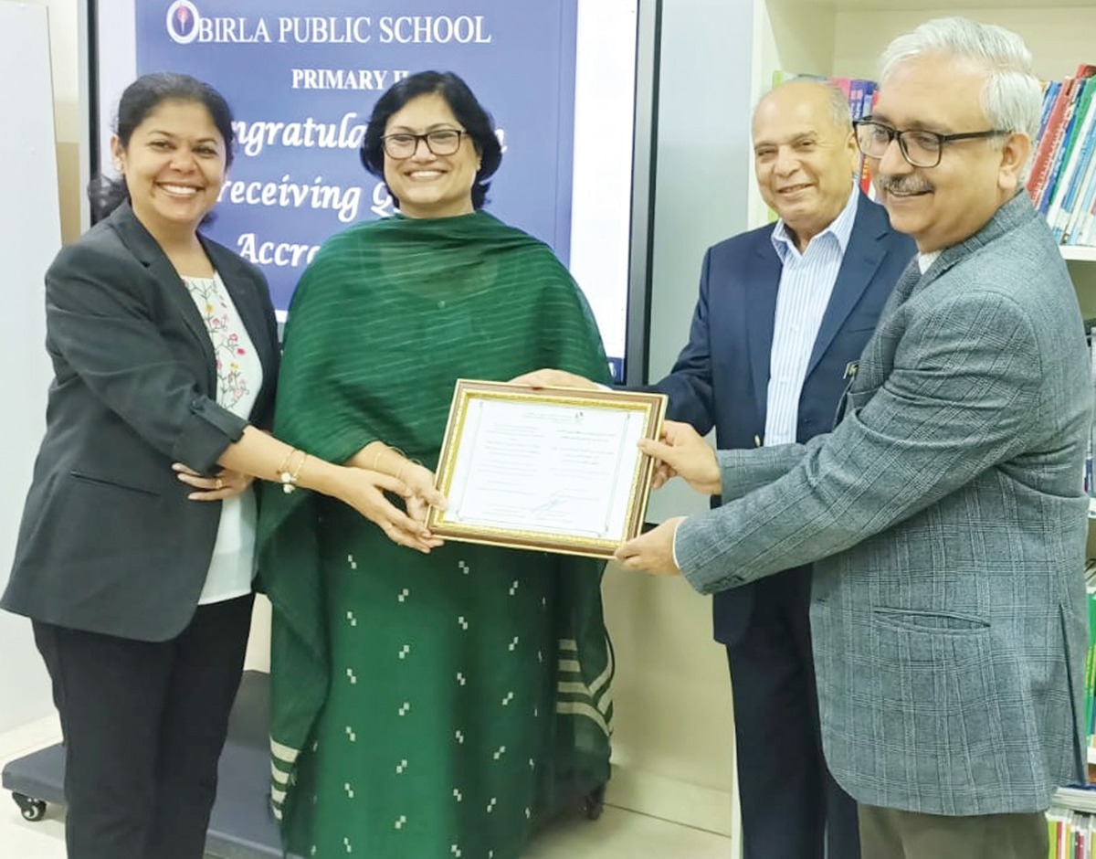 Birla Public School officials receiving QNSA Accreditation certificate.