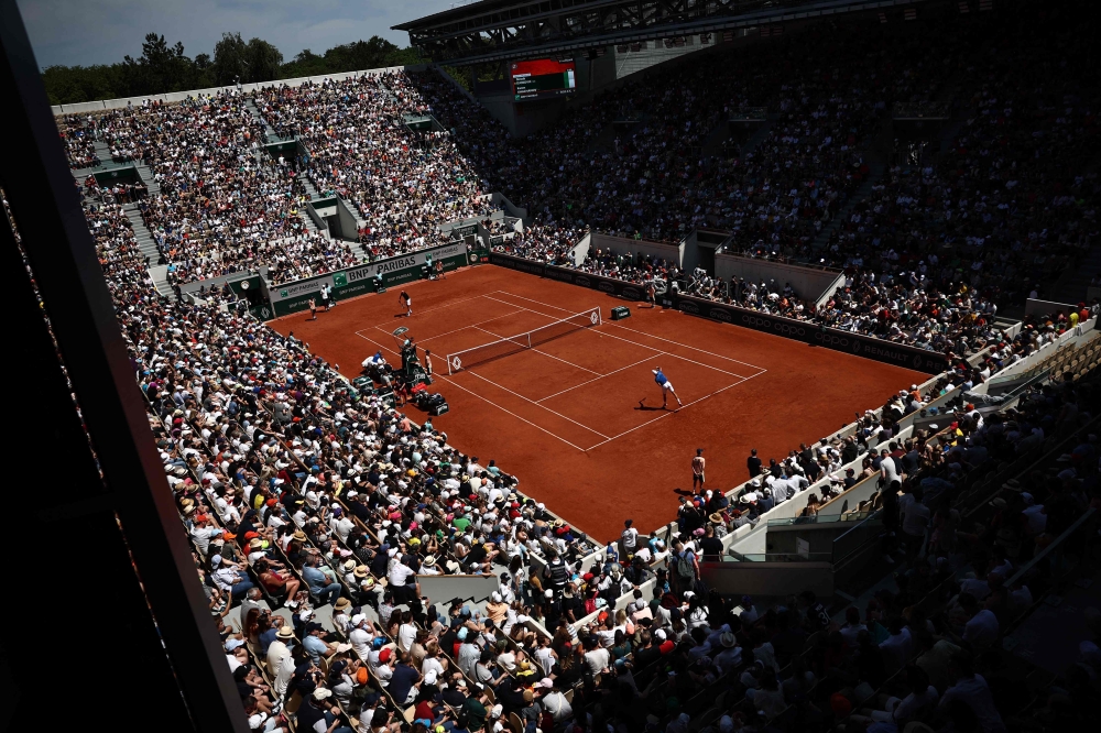Spectators watch an exhibition match between Serbia's Novak Djokovic and Russia's Karen Khachanov on the Court Suzanne-Lenglen ahead of the Roland-Garros Open tennis tournament in Paris on May 27, 2023. Photo by Anne-Christine POUJOULAT / AFP