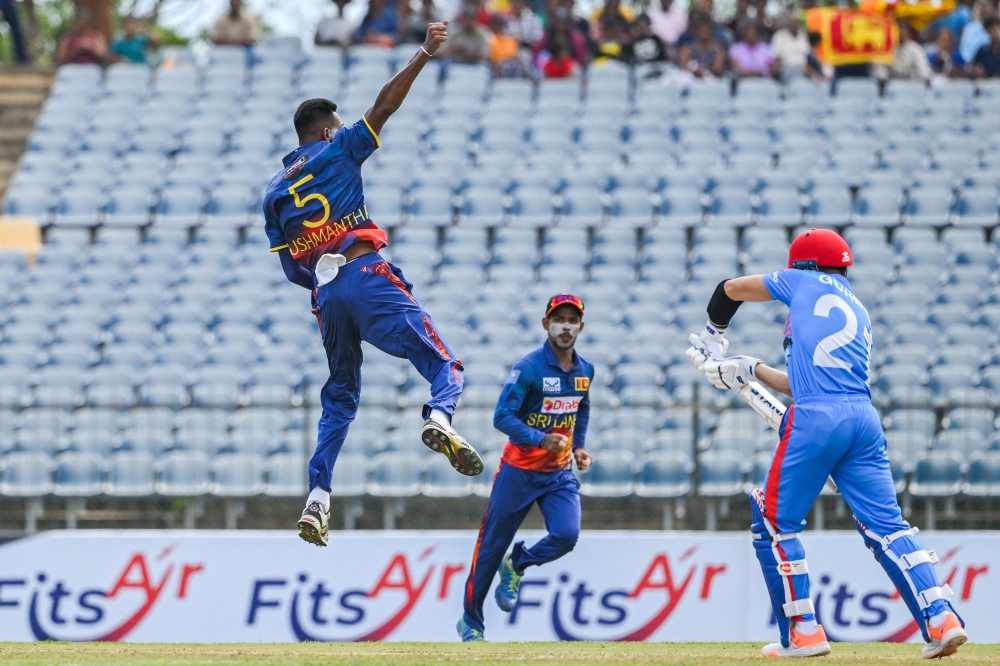 Sri Lanka's Dushmantha Chameera (L) celebrates after taking the wicket of Afghanistan's Rahmanullah Gurbaz (R) during the second one-day international (ODI) cricket match between Sri Lanka and Afghanistan at the Mahinda Rajapaksa International Cricket Stadium in Hambantota on June 4, 2023. (Photo by Ishara S. Kodikara / AFP)