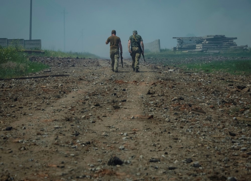 File Photo: Ukrainian service members walk on the road near the town of Soledar, amid Russia's invasion of Ukraine, Donetsk region, Ukraine June 8, 2022. (Reuters/Gleb Garanich)