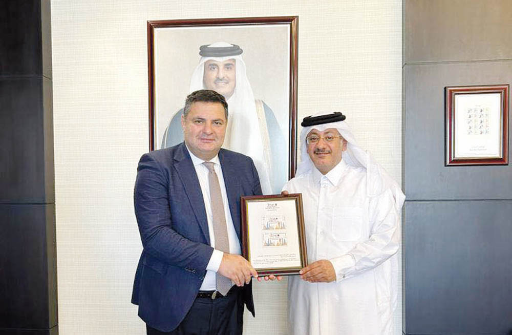 Chairman of Qatar Post Faleh Mohammed Al Nuaimi and Ambassador of Georgia to Qatar H E Nikoloz Revazishvili jointly presenting postage stamps.