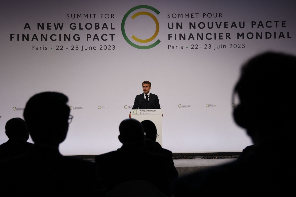 French President Emmanuel Macron delivers a speech during the opening session of the New Global Financial Pact Summit at the Palais Brogniart in Paris on June 22, 2023. (Photo by LUDOVIC MARIN / POOL / AFP)