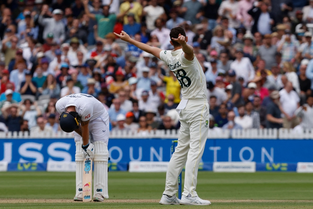 Australia's Josh Hazlewood (R) celebrates after taking the wicket of England's captain Ben Stokes (L) for 155 runs on day five of the second Ashes cricket Test match between England and Australia at Lord's cricket ground in London on July 2, 2023. (Photo by Ian Kington / AFP)
