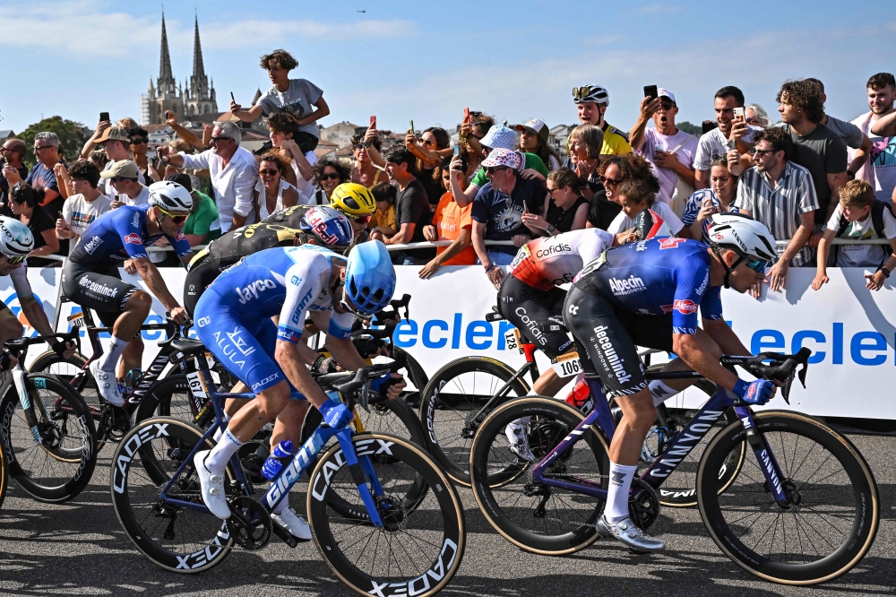 :Alpecin-Deceuninck's Belgian rider Jasper Philipsen (R) sprints ahead of Cofidis' German rider Simon Geschke (2nd R) and Team Jayco Alula's Slovenian rider Luka Mezgec (C) to the finish line to win the 3rd stage of the 110th edition of the Tour de France cycling race, 193,5 km between Amorebieta-Etxano in Northern Spain and Bayonne in southwestern France, on July 3, 2023. (Photo by Marco BERTORELLO / AFP)
