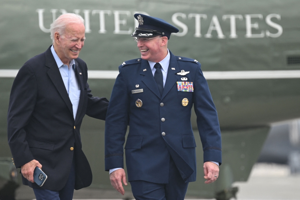 US President Joe Biden speaks with Colonel W Chris McDonald, Commander, Dover Air Force Base, as he walks to board Air Force One at Dover Air Force Base in Dover, Delaware, on July 9, 2023. (Photo by ANDREW CABALLERO-REYNOLDS / AFP)