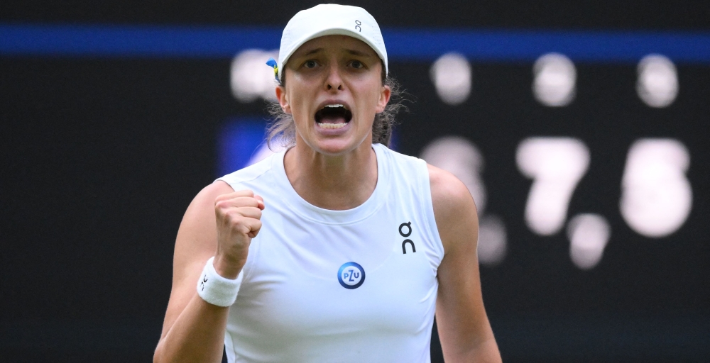 Poland's Iga Swiatek celebrates winning against Switzerland's Belinda Bencic during their women's singles tennis match on the seventh day of the 2023 Wimbledon Championships at The All England Tennis Club in Wimbledon, southwest London, on July 9, 2023. (Photo by Daniel Leal / AFP)