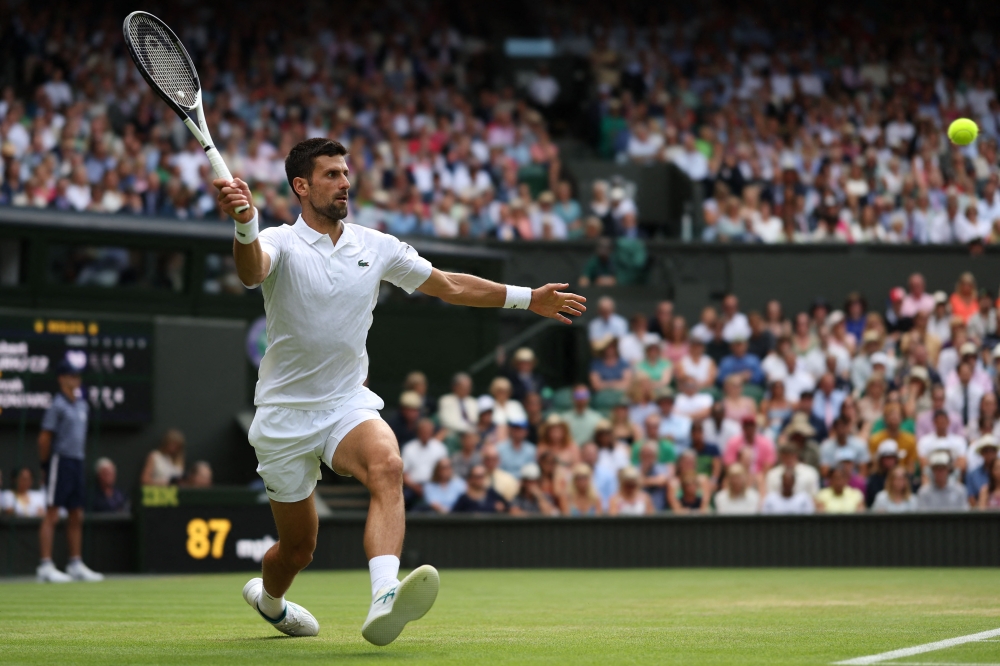 Serbia's Novak Djokovic returns the ball to Poland's Hubert Hurkacz during their men's singles tennis match on the eighth day of the 2023 Wimbledon Championships at The All England Tennis Club in Wimbledon, southwest London, on July 10, 2023. Photo by Adrian DENNIS / AFP