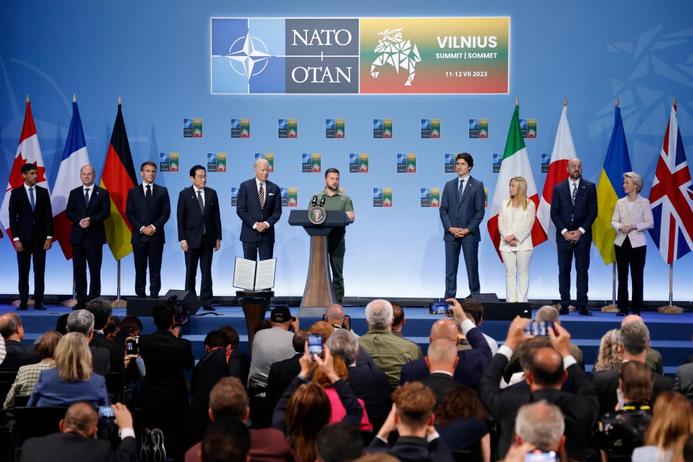(From left) Britain's Prime Minister Rishi Sunak, Germany's Chancellor Olaf Scholz, France's President Emmanuel Macron, Japan's Prime Minster Fumio Kishida, US President Joe Biden, Ukraine's President Volodymyr Zelensky, Canada's Prime Minister Justin Trudeau, Italy's Prime Minister Giorgia Meloni, European Council President Charles Michel and President of the European Commission Ursula von der Leyen attend an event to announce a Joint Declaration of Support for Ukraine during the NATO summit, in Vilnius on July 12, 2023. (Photo by Ludovic Marin / AFP)