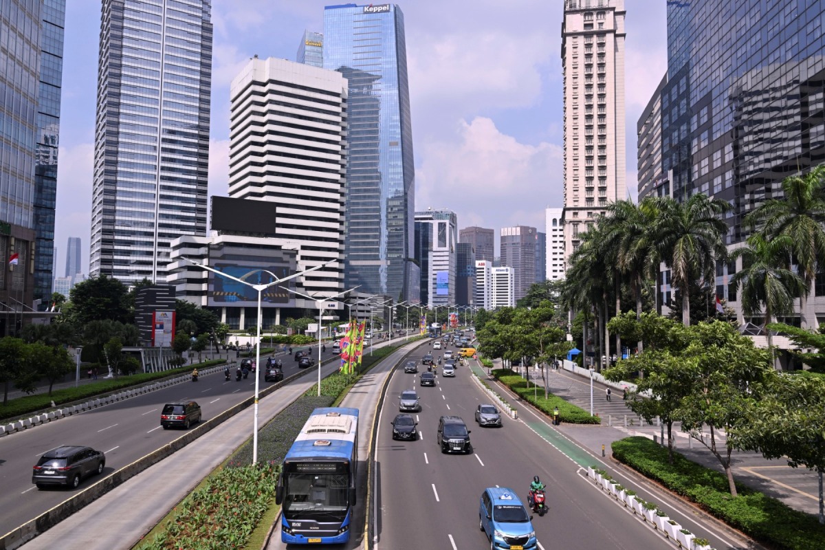 Vehicles are seen on a street in Jakarta on July 10, 2023. (Photo by ADEK BERRY / AFP)