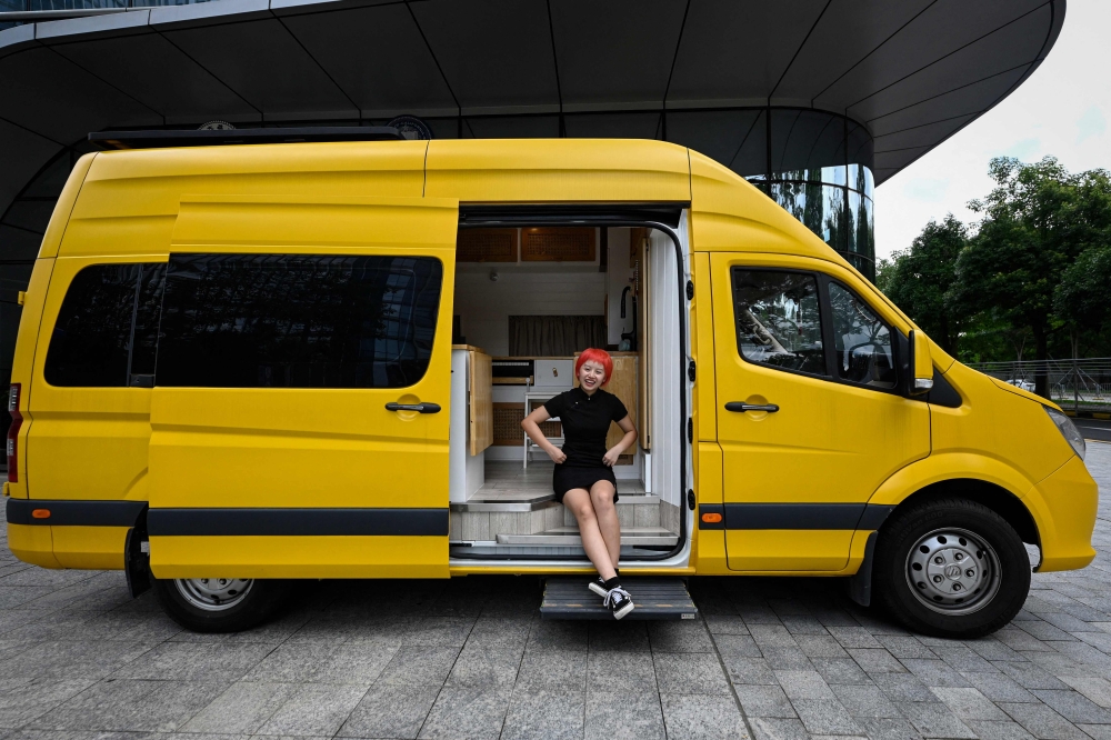 This photo taken on June 21, 2023 shows digital marketer Twiggy He sitting in her recreation vehicle (RV) in Shenzhen city, in southern China's Guangdong province. Photo by Jade GAO / AFP