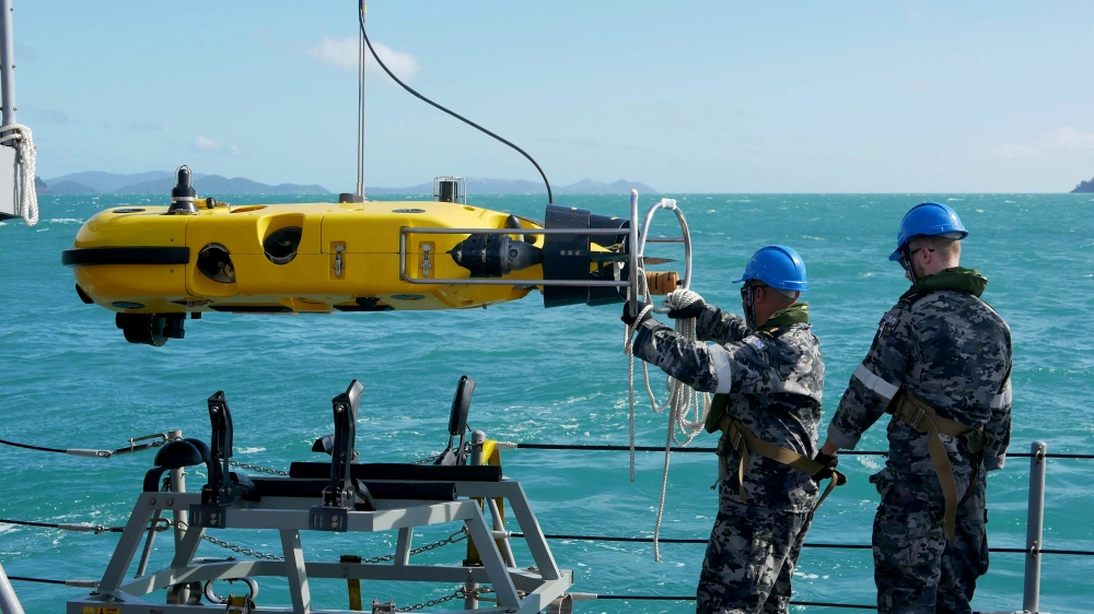 A handout photo taken on July 30, 2023 and received on August 3 from Australian Defence shows Royal Australian Navy sailors from HMAS Huon conducting search operations in the vicinity of Lindeman Island, Queensland. Human remains have been found at the site where an Australian military helicopter plunged into the sea off the country's northeast coast, authorities said on August 3. Photo by Casey Buurveld / AUSTRALIAN DEFENCE / AFP