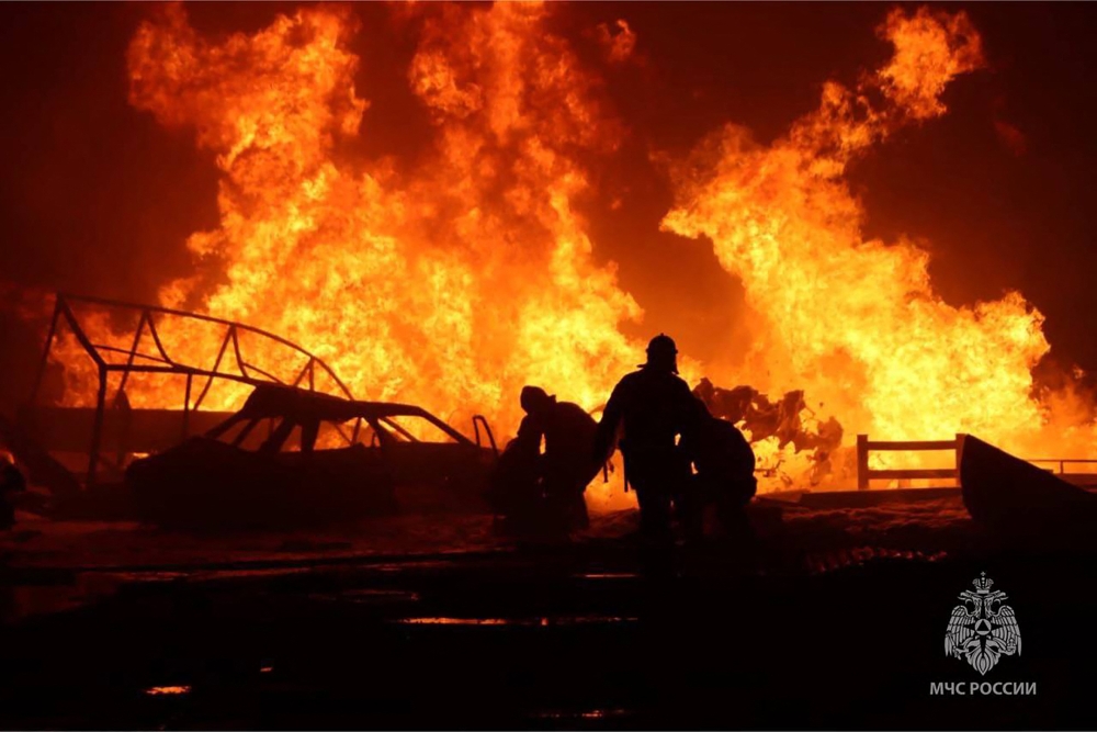 This handout photograph taken and released by Russian Emergency Ministry on August 14, 2023, shows rescuers pushing out a fire at a gas station in the city of Makhachkala. Photo by Handout / RUSSIAN EMERGENCY MINISTRY / AFP