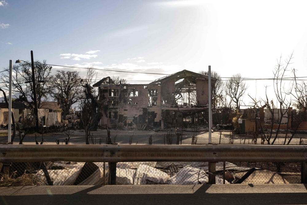 The charred frame of a house is seen among the ashes of a burnt neighborhood in the aftermath of a wildfire, in Lahaina, western Maui, Hawaii on August 14, 2023. Photos by Yuki IWAMURA / AFP