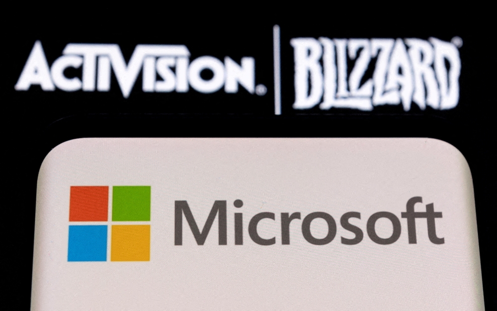 Microsoft logo is seen on a smartphone placed on displayed Activision Blizzard logo in this illustration taken January 18, 2022. File Photo / Reuters

