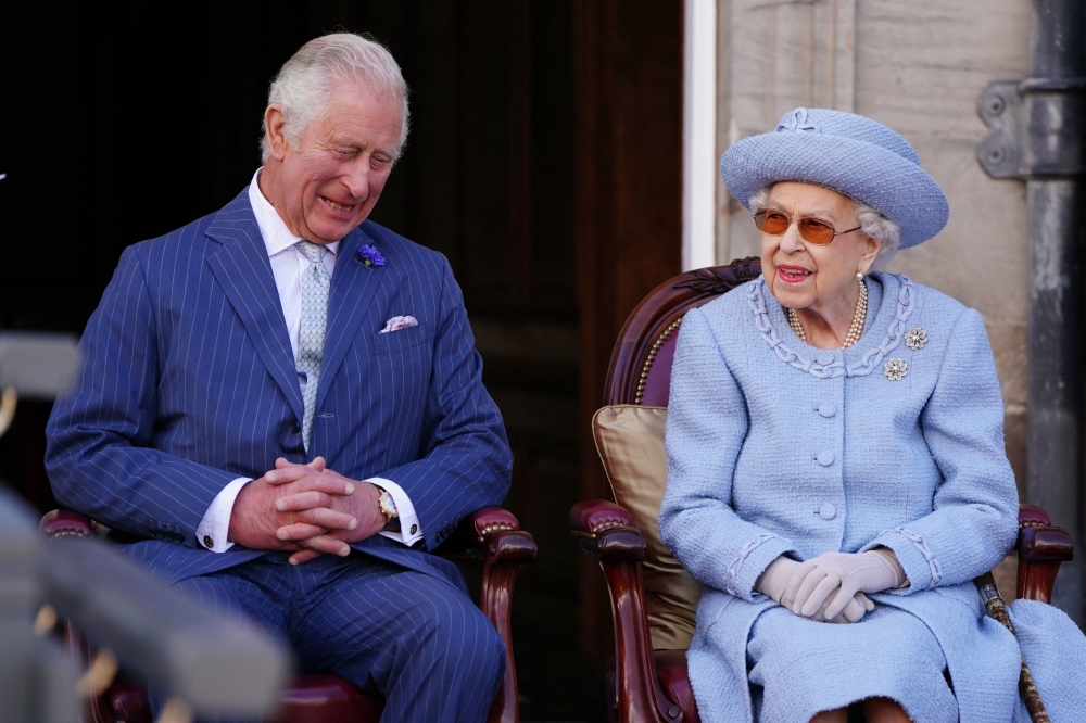 Britain's Prince Charles, Prince of Wales, known as the Duke of Rothesay when in Scotland and Britain's Queen Elizabeth II attend the Queen's Body Guard for Scotland (also known as the Royal Company of Archers) Reddendo Parade in the gardens of the Palace of Holyroodhouse in Edinburgh on June 30, 2022. Britain on Friday, September 8, mark the first anniversary of Queen Elizabeth II's death but commemorations will be low-key with no official public events planned. Photo by Jane Barlow / POOL / AFP