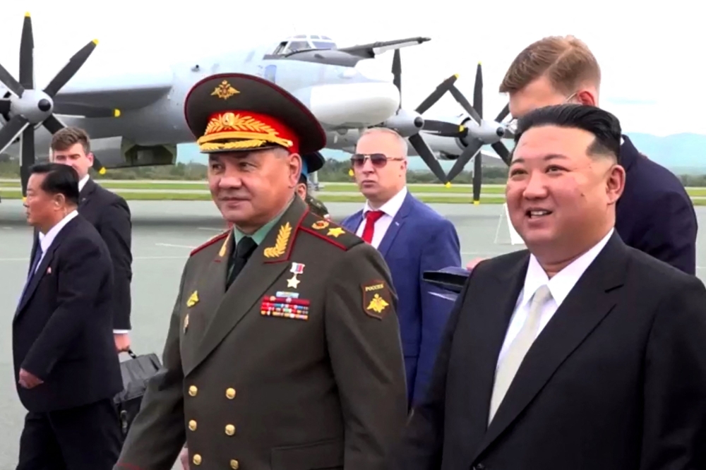 In this video grab taken from footage released on September 16, 2023 by Russian Defence Ministry, North Korea's leader Kim Jong Un (R) and Russia's Defence Minister Sergei Shoigu (L) visit Knevichi aerodrome near Vladivostok, Primorsky region. (Photo by Handout / Russian Defence Ministry / AFP) 