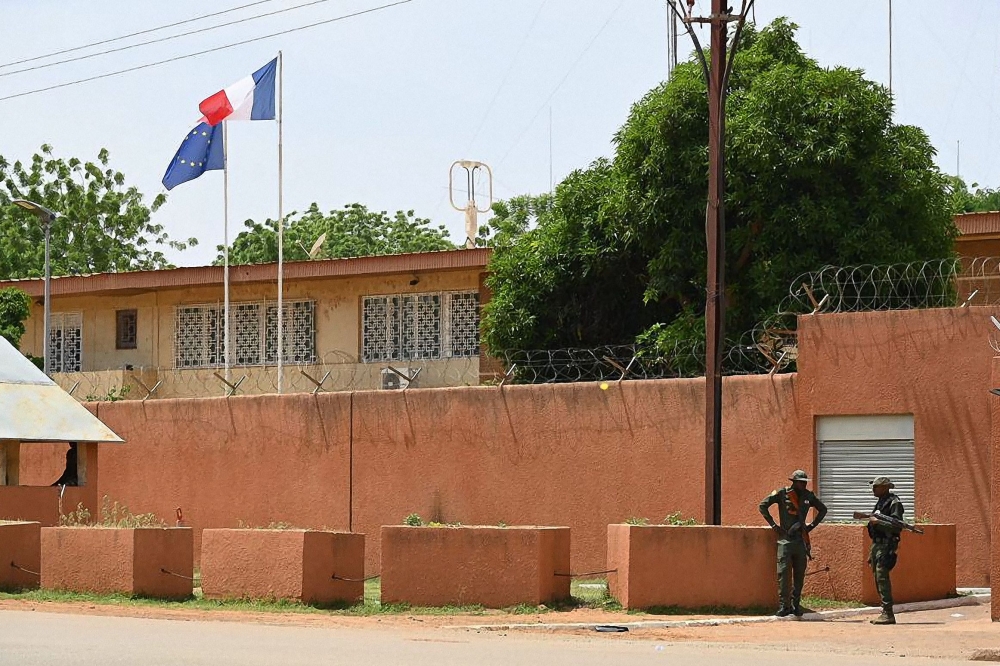 (Files) Officers of the Niger national Police are seen outside the French Embassy in Niamey on August 28, 2023. (Photo by AFP)
 