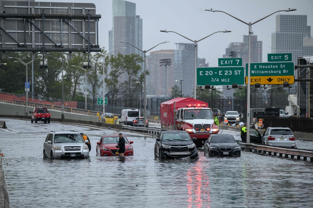 Cars in floodwater on the FDR highway in Manhattan, New York on September 29, 2023. (Photo by Ed Jones/ AFP)