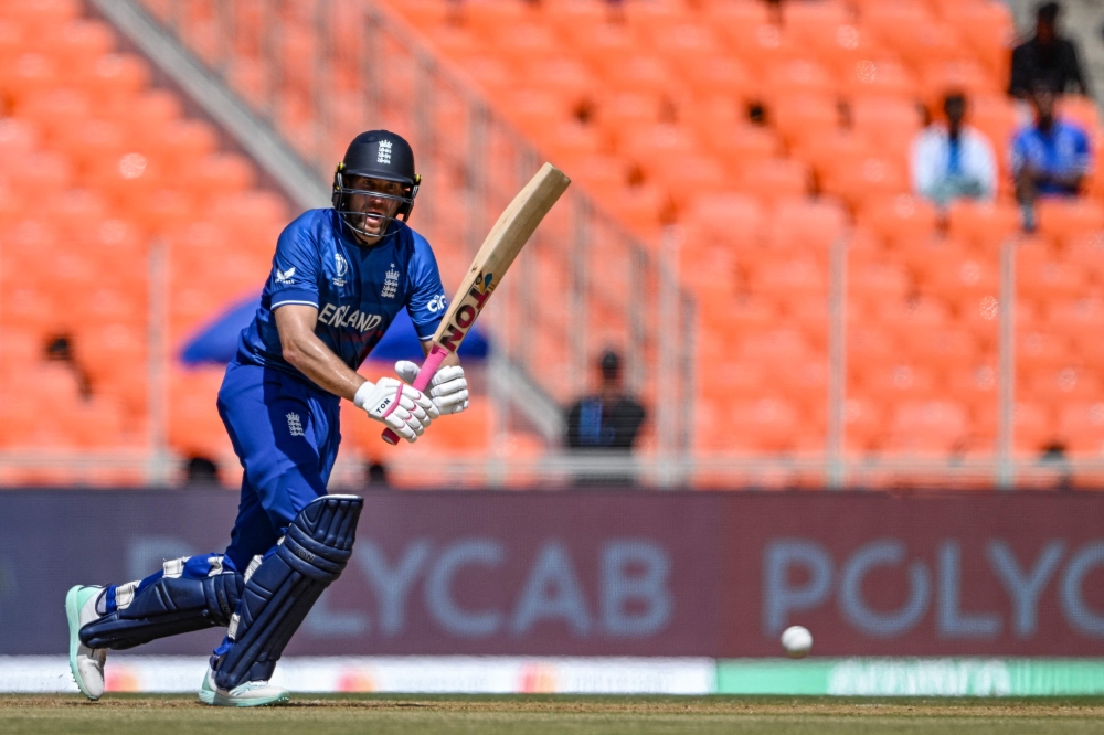 England's Dawid Malan plays a shot during the 2023 ICC men's cricket World Cup one-day international (ODI) match between England and New Zealand at the Narendra Modi Stadium in Ahmedabad on October 5, 2023. (Photo by Punit Paranjpe / AFP) /
