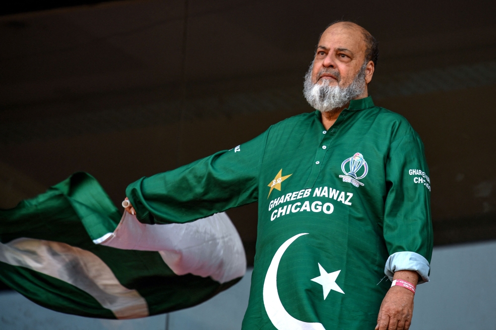 Chacha Mohammad Basheer, a Pakistani fan, waves national flag during the 2023 ICC Men's Cricket World Cup one-day international (ODI) match between Pakistan and Netherlands at the Rajiv Gandhi International Stadium in Hyderabad, India, on October 6, 2023. (Photo by Noah Seelam / AFP)