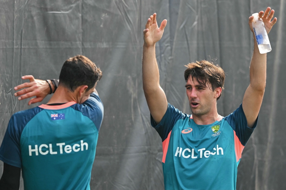 Australia's captain Pat Cummins (R) attends a practice session ahead of the 2023 ICC men's cricket World Cup one-day international (ODI) match between India and Australia at the MA Chidambaram Stadium in Chennai on October 6, 2023. (Photo by R. Satish Babu / AFP) 