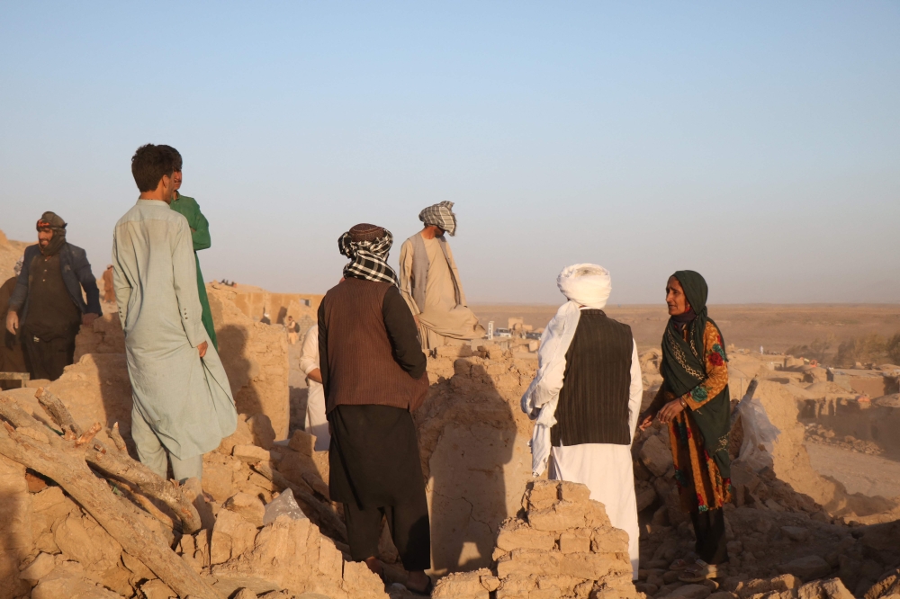 Afghan residents clear debris from a damaged house after earthquake in Sarbuland village of Zendeh Jan district of Herat province on October 7,2023 (Photo by Mohsen Karimi / AFP)