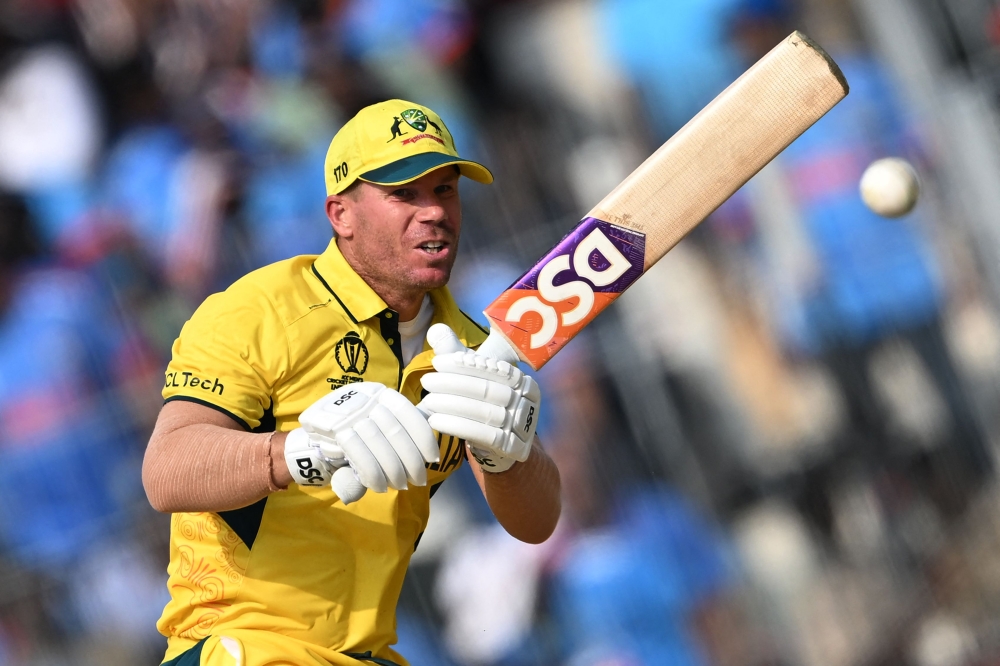 Australia's David Warner plays a shot during the 2023 ICC Men's Cricket World Cup one-day international (ODI) match between India and Australia on October 8, 2023. (Photo by Punit Paranjpe / AFP)