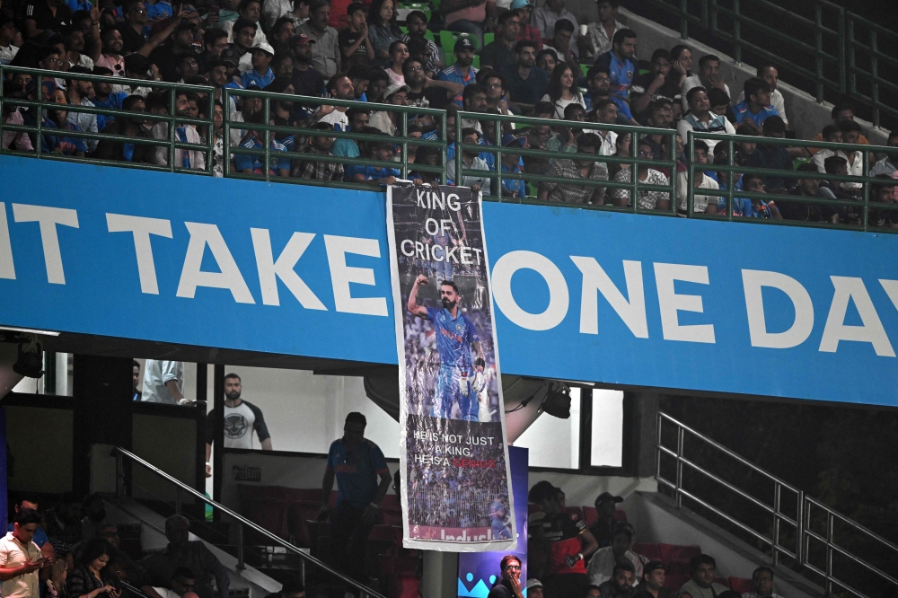 Spectators watch the 2023 ICC Men's cricket World Cup one-day international (ODI) match between India and Afghanistan at the Arun Jaitley Stadium in New Delhi on October 11, 2023. (Photo by Money Sharma / AFP) 