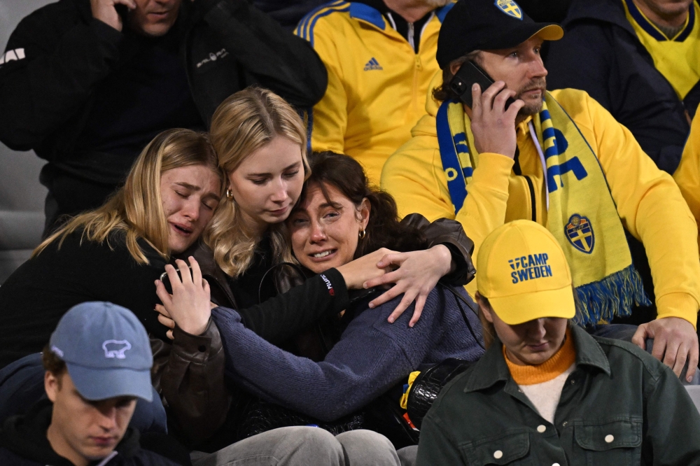 Swedish supporters react as they wait in the stand during the Euro 2024 qualifying football match between Belgium and Sweden at the King Baudouin Stadium in Brussels on October 16, 2023, after an 'attack' that targeted Swedish citizens in a street of Brussels. (Photo by John Thys / AFP)