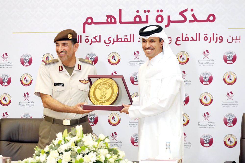 QFA President Jassim bin Rashid Al Buenain presents a memento to NSA’s Major General Hamad bin Ahmed Al Nuaimi after signing the MoU yesterday.   