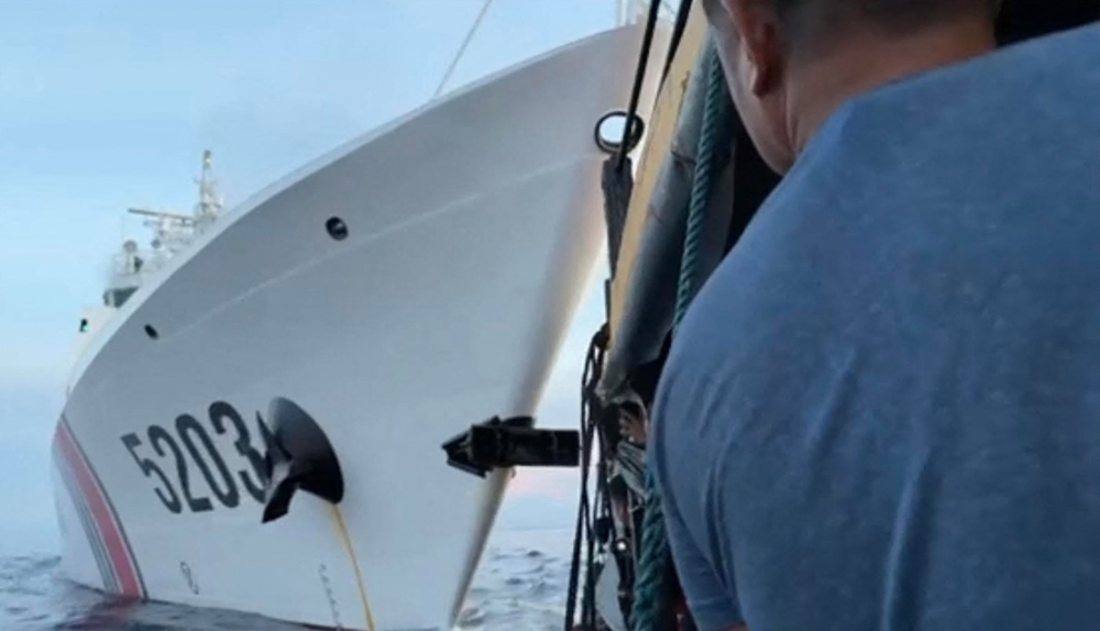 This videograb taken and released on October 22, 2023, by the Armed Forces of the Philippines (AFP) shows a collision between a Chinese Coast Guard ship (L) and Philippines' resupply boat (R) during a resupply mission near the Second Thomas Shoal, in the disputed South China Sea. Beijing and Manila traded blame on October 22, for two collisions between Chinese vessels and Philippine boats on a resupply mission to Filipino troops on a remote outpost in the disputed South China Sea. (Photo by ARMED FORCES OF THE PHILIPPINES / AFP)