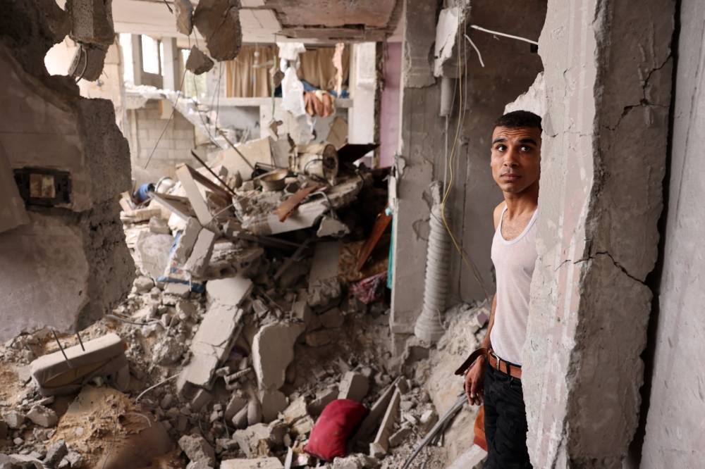 A man stands amid the rubble of a building in the aftermath of Israeli bombing in Rafah in the southern Gaza Strip on October 29, 2023. Photo by MOHAMMED ABED / AFP