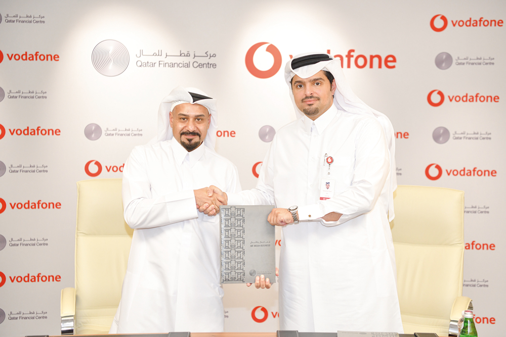 Vodafone Qatar Chief Executive Officer Sheikh Hamad Abdulla Jassim Al Thani and QFC Chief Executive Officer Yousuf Mohamed Al Jaida during the agreement signing.